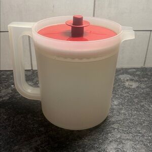 1 1/2 qt semi sheer And Brick Red Plastic Pitcher by Tupperware. Push button lid